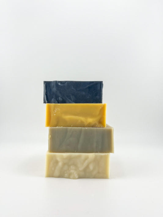 Pictured is Activated Charcoal, Herbal Citrus, Sea Clay and our Well Balanced cold processed soap bars. 